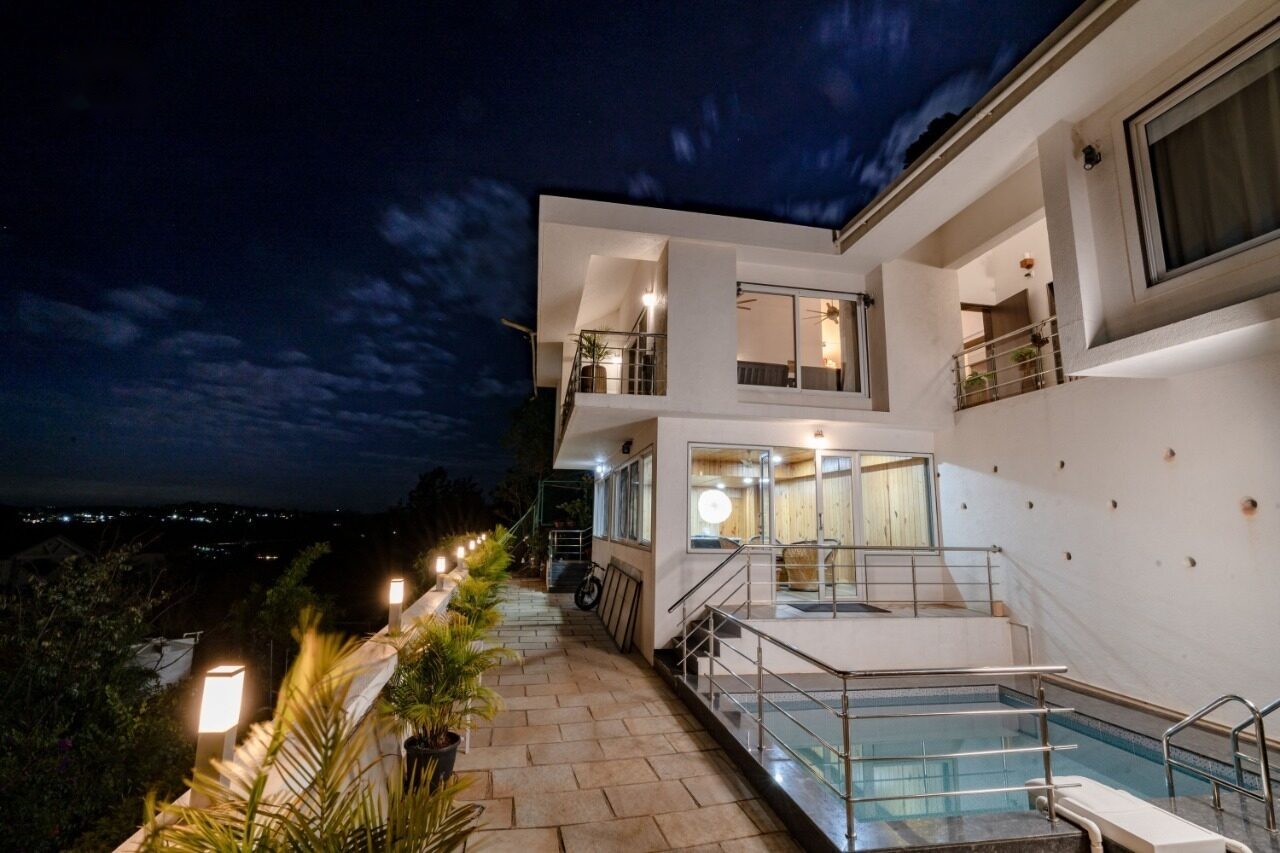 PQ Villa pool lit up at night with hilltop views